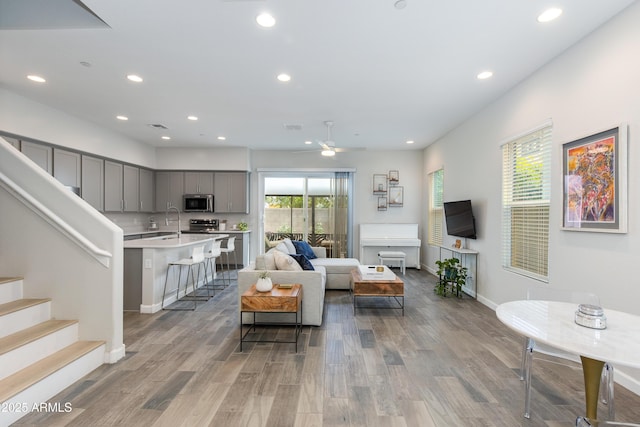 3045 N 37th Way, Phoenix, AZ 85018 - living room featuring baseboards, a ceiling fan, light wood-style flooring, and recessed lighting
