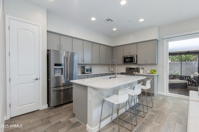 3045 N 37th Way, Phoenix, AZ 85018 - kitchen with appliances with stainless steel finishes, gray cabinetry, a sink, and visible vents
