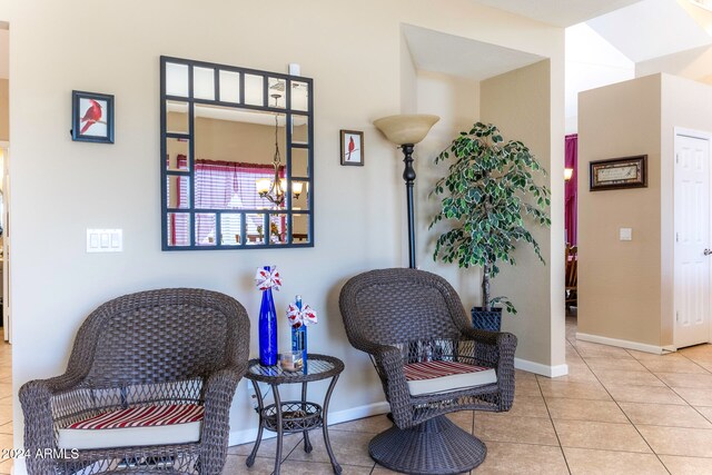 living area featuring a chandelier and light tile patterned floors