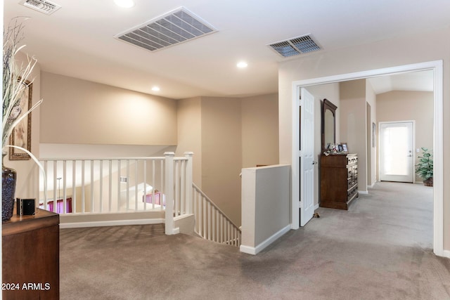 hall with light colored carpet and lofted ceiling