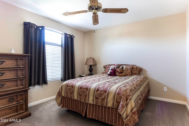 bedroom featuring ceiling fan and dark colored carpet