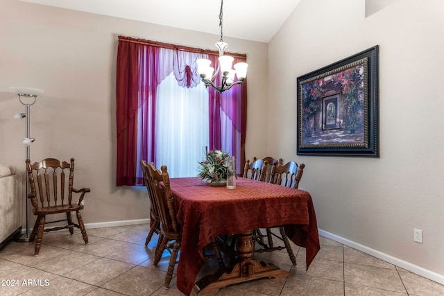 dining area featuring a chandelier, tile patterned flooring, and lofted ceiling