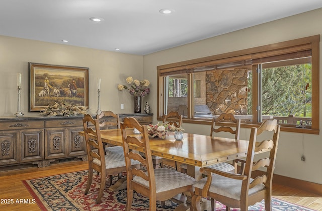 dining space with light wood-style floors and recessed lighting