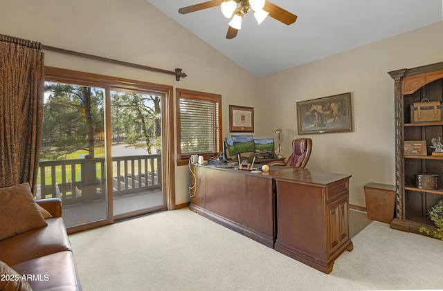 office area with baseboards, light carpet, a ceiling fan, and lofted ceiling