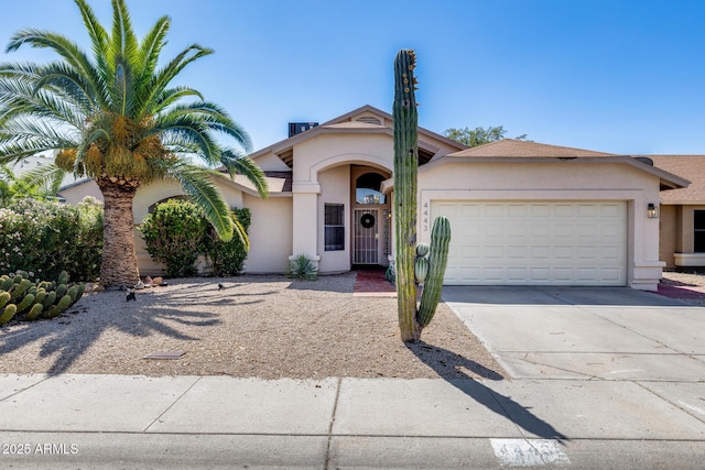 4443 W Escuda Dr, Glendale, AZ 85308 - view of front facade with stucco siding, an attached garage, and driveway