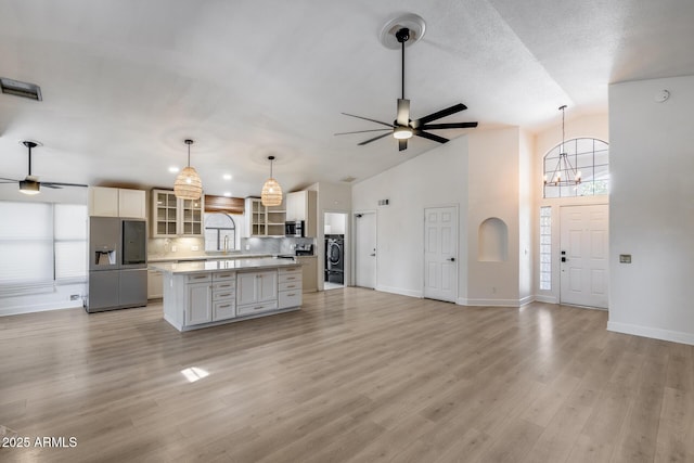 4443 W Escuda Dr, Glendale, AZ 85308 - kitchen featuring appliances with stainless steel finishes, a ceiling fan, a center island, plenty of natural light, and high vaulted ceiling