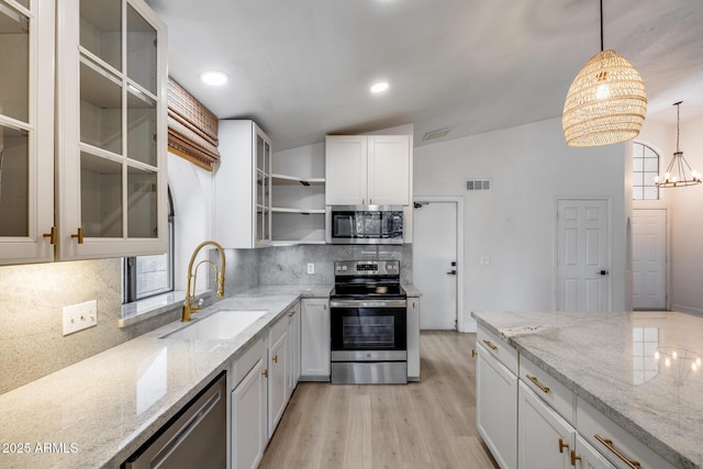 4443 W Escuda Dr, Glendale, AZ 85308 - kitchen with appliances with stainless steel finishes, a sink, decorative backsplash, light wood-type flooring, and open shelves