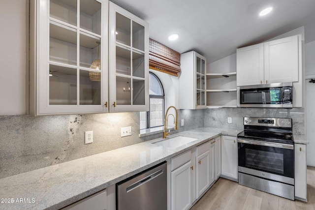 4443 W Escuda Dr, Glendale, AZ 85308 - kitchen featuring appliances with stainless steel finishes, a sink, light stone countertops, white cabinets, and recessed lighting