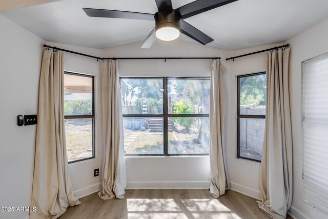 4443 W Escuda Dr, Glendale, AZ 85308 - empty room featuring light wood-style flooring, lofted ceiling, baseboards, and a ceiling fan