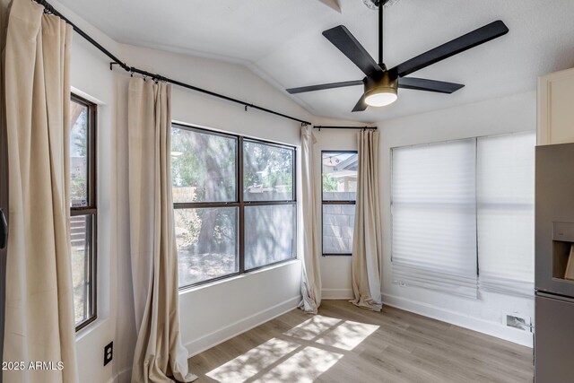4443 W Escuda Dr, Glendale, AZ 85308 - unfurnished room featuring lofted ceiling, baseboards, a ceiling fan, and light wood-type flooring