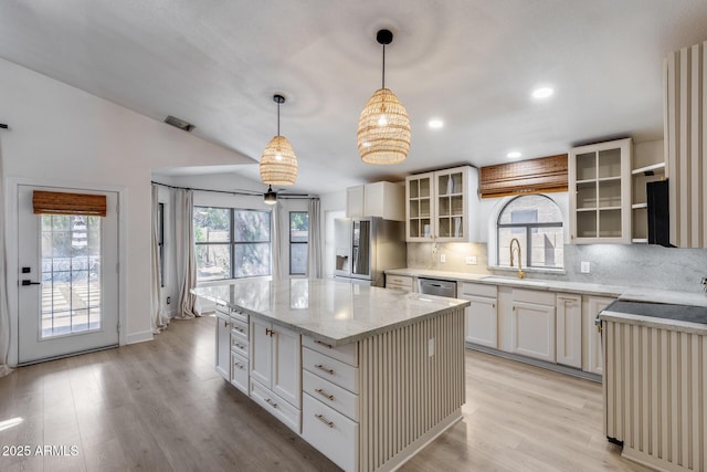 4443 W Escuda Dr, Glendale, AZ 85308 - kitchen with a sink, decorative backsplash, stainless steel appliances, a kitchen island, and light stone counters