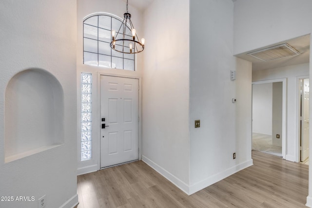 4443 W Escuda Dr, Glendale, AZ 85308 - entrance foyer featuring light wood-style floors, a chandelier, baseboards, and a high ceiling