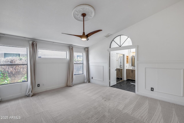 4443 W Escuda Dr, Glendale, AZ 85308 - carpeted spare room featuring healthy amount of natural light, a decorative wall, a wainscoted wall, ceiling fan, and lofted ceiling