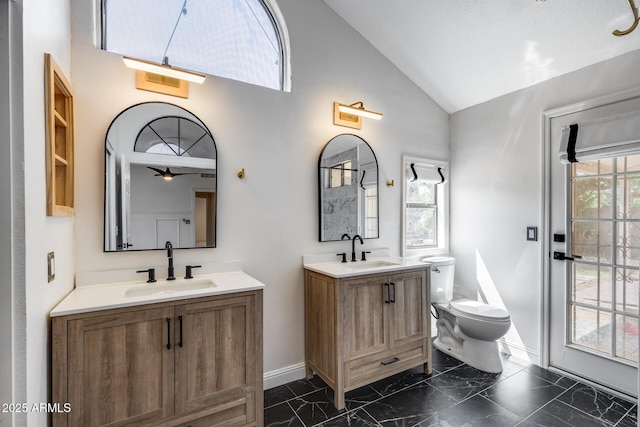 4443 W Escuda Dr, Glendale, AZ 85308 - full bathroom featuring baseboards, two vanities, marble finish floors, toilet, and a ceiling fan