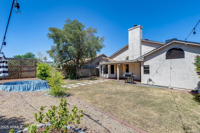 4443 W Escuda Dr, Glendale, AZ 85308 - back of property with a chimney, stucco siding, and a patio