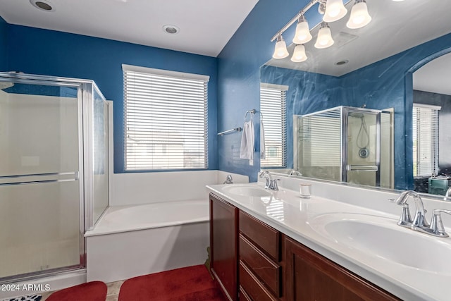 bathroom featuring shower with separate bathtub and vanity