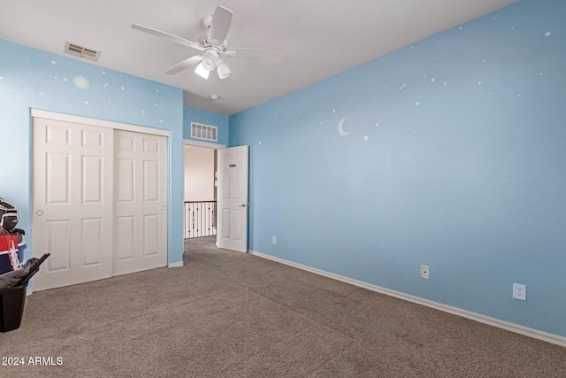 unfurnished bedroom featuring ceiling fan, a closet, and carpet