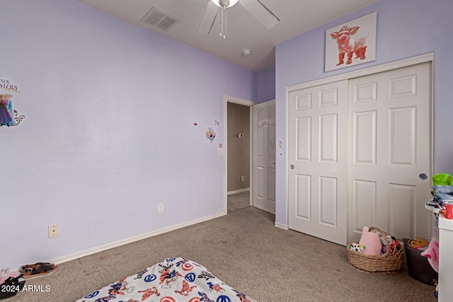 carpeted bedroom with a closet and ceiling fan