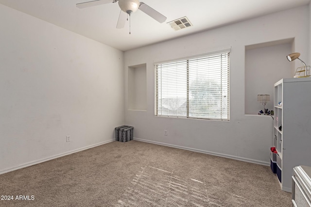 carpeted empty room featuring ceiling fan