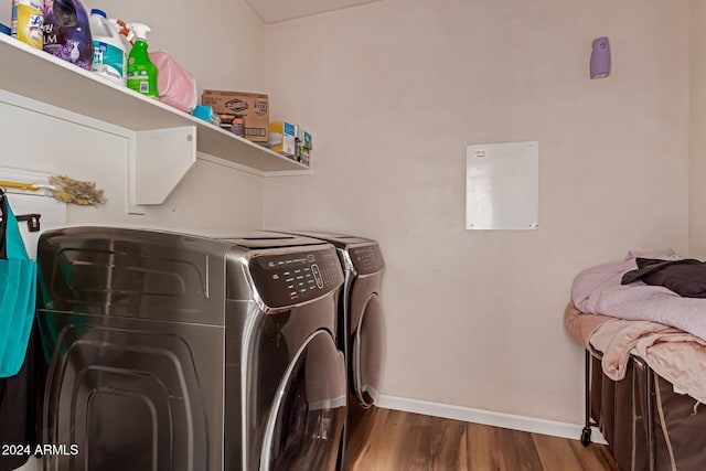 washroom with washing machine and dryer and dark hardwood / wood-style flooring