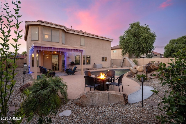 10617 W Daley Ln, Peoria, AZ 85383 - back of house featuring an outdoor fire pit, a patio area, stucco siding, and a fenced backyard