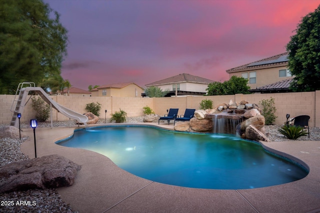 10617 W Daley Ln, Peoria, AZ 85383 - view of swimming pool featuring a water slide, a fenced backyard, and a patio area