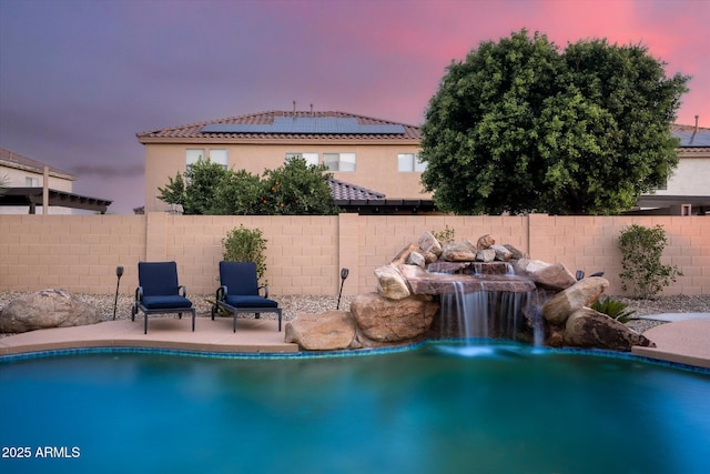 10617 W Daley Ln, Peoria, AZ 85383 - pool at dusk with a fenced backyard