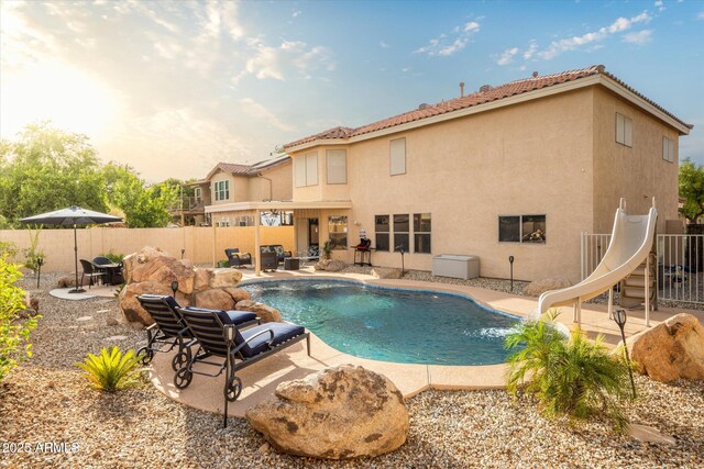 10617 W Daley Ln, Peoria, AZ 85383 - view of swimming pool featuring a water slide, a patio, and a fenced backyard