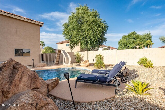 10617 W Daley Ln, Peoria, AZ 85383 - view of pool with a water slide, a fenced backyard, and a patio area