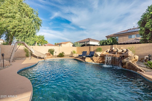 10617 W Daley Ln, Peoria, AZ 85383 - view of pool with a water slide and a fenced backyard