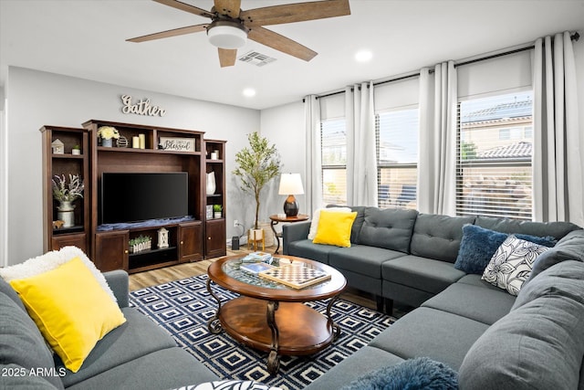 10617 W Daley Ln, Peoria, AZ 85383 - living room featuring healthy amount of natural light, a ceiling fan, light wood-type flooring, and recessed lighting