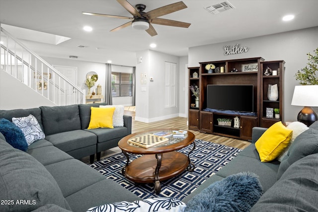 10617 W Daley Ln, Peoria, AZ 85383 - living room with stairway, light wood finished floors, ceiling fan, baseboards, and recessed lighting