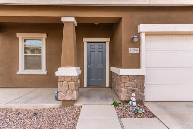 view of exterior entry featuring a garage