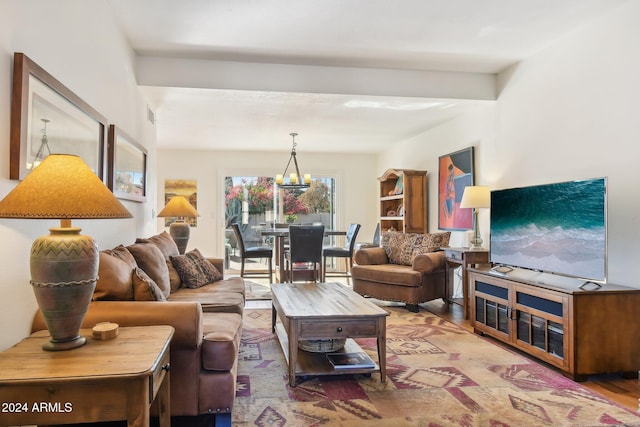 living room with hardwood / wood-style floors and an inviting chandelier