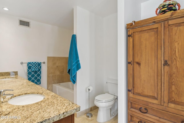 bathroom with vanity, tile patterned flooring, a bathtub, and toilet