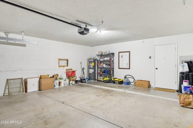 garage with water heater and a garage door opener