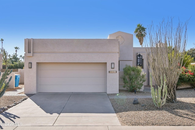 southwest-style home featuring a garage