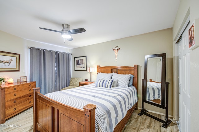 bedroom featuring light wood-type flooring, a ceiling fan, and a closet