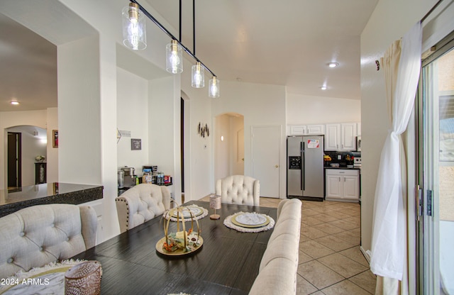 tiled dining area with lofted ceiling