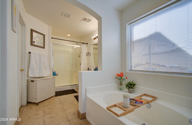 bathroom featuring separate shower and tub and tile patterned flooring