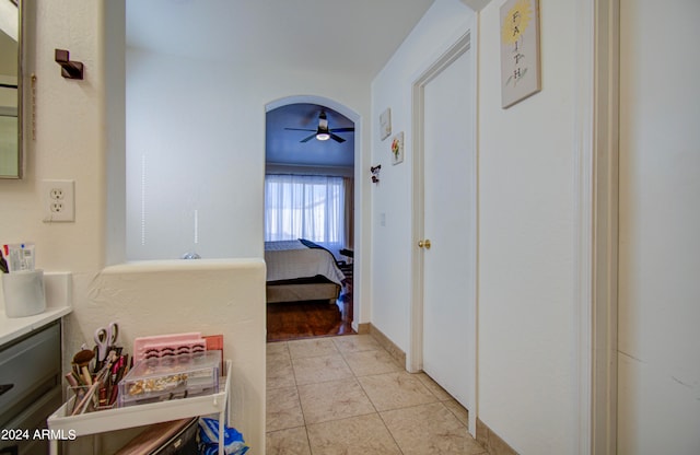 interior space with vanity, tile patterned flooring, and ceiling fan