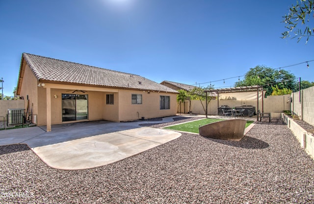 rear view of property featuring a patio and cooling unit