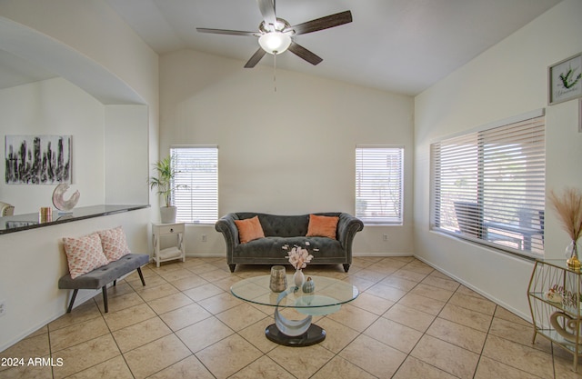 living area featuring vaulted ceiling, ceiling fan, and light tile patterned flooring