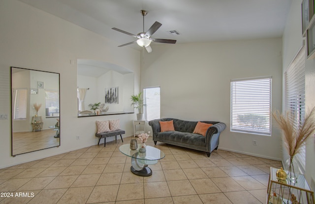 tiled living room featuring high vaulted ceiling and ceiling fan