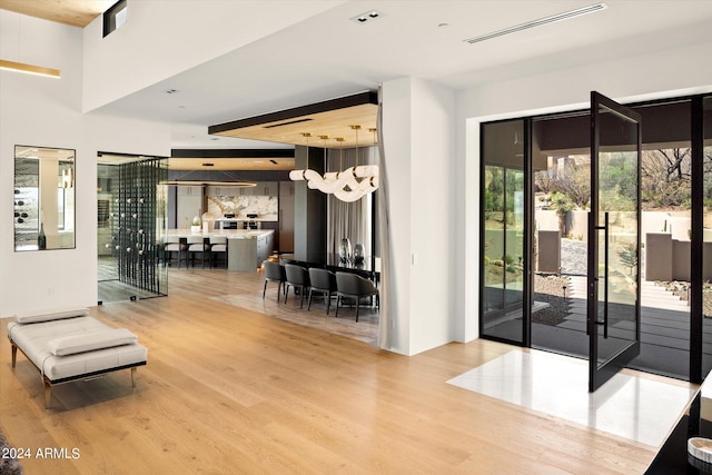 interior space featuring light hardwood / wood-style flooring and a towering ceiling