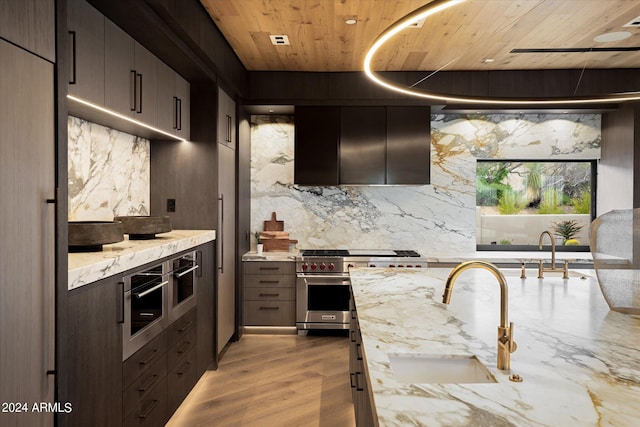 kitchen featuring sink, light stone counters, appliances with stainless steel finishes, wooden ceiling, and light wood-type flooring