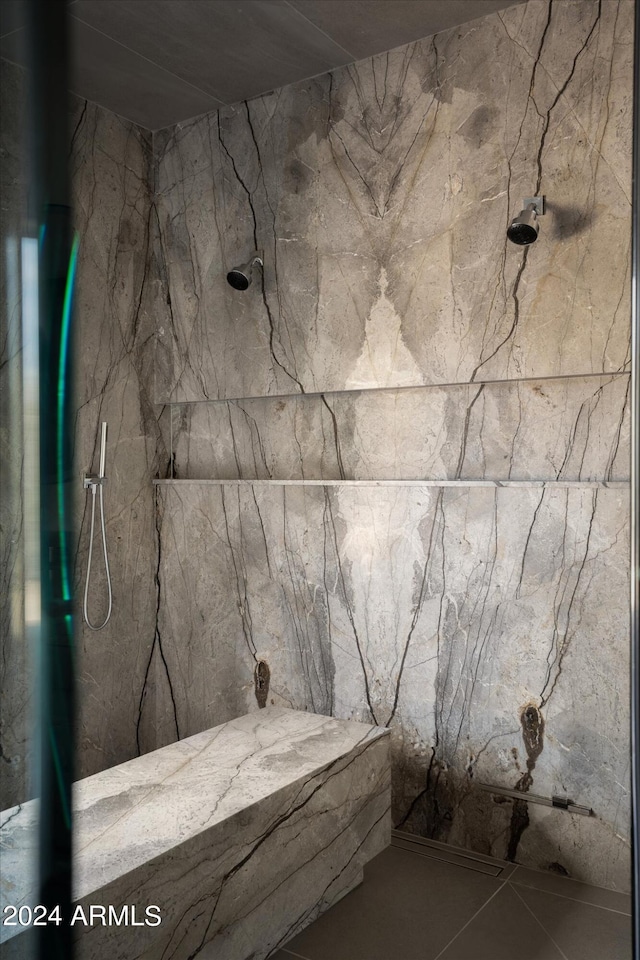 bathroom with tile flooring and a tile shower