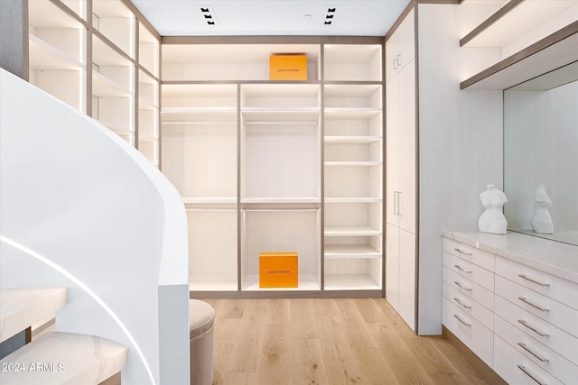 walk in closet featuring light hardwood / wood-style flooring