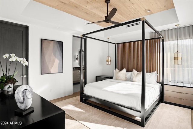 bedroom with ceiling fan, ensuite bathroom, wood ceiling, and light hardwood / wood-style floors