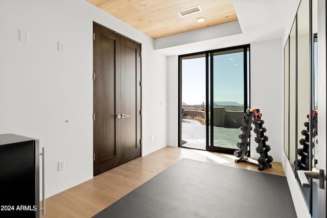 interior space with wooden ceiling and light hardwood / wood-style flooring